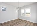 Bright dining area with hardwood floors and a modern light fixture at 908 Allen Park Dr, Raleigh, NC 27604