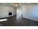 Spacious living room with hardwood floors, a fireplace, and built-in shelving at 344 Longbow Dr, Middlesex, NC 27557