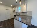 Modern kitchen with granite countertops and white cabinets at 376 Longbow Dr, Middlesex, NC 27557