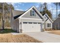 Gray-sided house with white trim and a large two-car garage at 153 Wilderness Trl, Smithfield, NC 27577