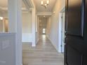 Bright foyer with light wood floors leading into the home's open-concept living spaces and a glimpse of coffered ceilings at 639 Sweet Potato Lane # 3, Nashville, NC 27856
