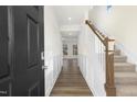 Inviting entryway showcasing hardwood floors, staircase, and wainscoting at 82 Gander Dr, Benson, NC 27504