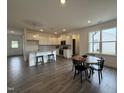 Open kitchen and dining area with stainless steel appliances, island, and sleek flooring at 234 Danube Dr, Zebulon, NC 27597
