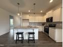 Modern kitchen featuring white cabinets, stainless steel appliances, and a granite island at 234 Danube Dr, Zebulon, NC 27597