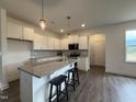 Modern kitchen featuring white cabinets, stainless steel appliances, and a granite island at 234 Danube Dr, Zebulon, NC 27597