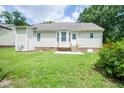 This backyard shows a patio area, perfect for outdoor seating and entertaining at 310 E Horton St, Zebulon, NC 27597