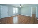 Spacious living room with hardwood floors, bright windows, and fresh neutral paint at 310 E Horton St, Zebulon, NC 27597