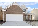 Two-story brick home with a white garage door at 36 Steppe Way, Garner, NC 27529