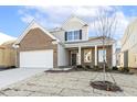 Two-story house with brick and siding, featuring a front yard at 36 Steppe Way, Garner, NC 27529