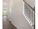 Light and airy hallway with hardwood floors and access to other rooms at 160 Perseus St, Angier, NC 27501