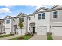 Two-story townhome with gray siding, two-car garage, and landscaping at 168 Perseus St, Angier, NC 27501