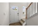 Bright entryway with stairs, wood floors, and a view to the backyard at 172 Perseus St, Angier, NC 27501