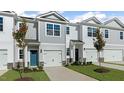 Two-story townhome with gray siding, white trim, and a two-car garage at 172 Perseus St, Angier, NC 27501