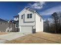 Two-story white house with stone accents and a two-car garage at 414 Fast Pitch Ln, Four Oaks, NC 27524