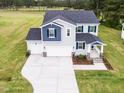 Charming two-story home with a wide driveway and a lush green lawn at 576 Barbour Farm Ln, Four Oaks, NC 27524