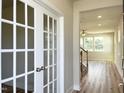 Elegant foyer featuring hardwood floors, bright lighting, and stylish French doors leading to an office at 576 Barbour Farm Ln, Four Oaks, NC 27524