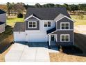 Aerial view of a charming two-story home with a two-car garage and a well-kept lawn at 674 Barbour Farm Ln, Four Oaks, NC 27524