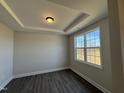 Bright bedroom with large window and neutral walls at 99 Mapledale Ct, Benson, NC 27504