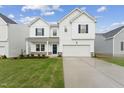 Charming two-story home with a well-manicured lawn, a covered porch, and a two-car garage at 516 Marthas View Way, Rolesville, NC 27587