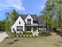 Elegant two-story home featuring dark trim, brick accents, and a well-kept lawn at 7417 Dover Hills Dr, Wake Forest, NC 27587