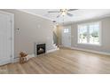 Bright living room boasts a fireplace, ceiling fan, and natural light from the window at 98 Linda St, Princeton, NC 27569