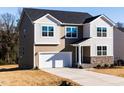 Beautiful two-story home with a two-car garage and landscaped front yard and manicured lawn at 370 Fast Pitch Ln, Four Oaks, NC 27524