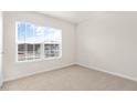 Bright bedroom featuring a large window with natural light and neutral carpeting at 3604 Drafton Dr, Raleigh, NC 27610
