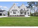 Beautiful two-story home boasts a manicured lawn and a modern aesthetic with black accents at 2506 Silas Peak Ln, Apex, NC 27523