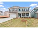 Attractive home exterior with blue siding, brick accents, and a well-maintained lawn and landscaping at 124 August Pond Way # 138, Raleigh, NC 27603