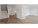 Inviting foyer with wood-look floors, staircase, and arched doorway at 134 Black Walnut Dr # 205, Garner, NC 27529