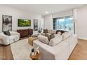 Relaxing living room with a comfortable sectional, modern media console, and view of the outdoor landscape at 208 Regency Ridge Dr, Holly Springs, NC 27540