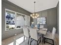 An elegant dining room features paneled walls, modern lighting, and large windows at 4800 Lakemont Dr, Raleigh, NC 27609