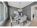 An elegant dining room features paneled walls, modern lighting, and bright light at 4800 Lakemont Dr, Raleigh, NC 27609
