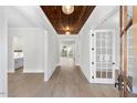 Bright and spacious entryway with hardwood floors and a wood accent ceiling at 114 Sanderway Dr, Chapel Hill, NC 27516