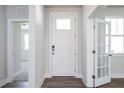 Bright entryway with wood floors, featuring a white front door, a glass panel door, and an open view at 818 Barbour Farm Ln, Four Oaks, NC 27524