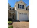 Two-story townhome with attached garage and landscaped front yard at 5543 Nur Ln, Raleigh, NC 27606