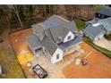 Aerial view of a new construction home featuring gray shingles, black gutters and an attached garage at 1101 Manchester, Raleigh, NC 27609