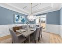 Elegant dining room featuring stylish decor, a modern chandelier, and large window at 2812 Theresa Eileen Way, Raleigh, NC 27603