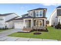 Charming two-story home features a two-car garage and a welcoming front porch with stone accents at 808 Challenger Ln, Knightdale, NC 27545