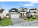 Charming two-story home features a two-car garage and a welcoming front porch with stone accents at 808 Challenger Ln, Knightdale, NC 27545