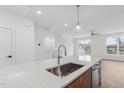 Kitchen island with quartz countertop and stainless steel sink and faucet at 448 Billingshurst Way, Knightdale, NC 27545