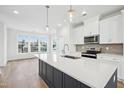 Modern kitchen features a large center island, stainless steel appliances, and hardwood floors at 506 Billingshurst Way, Knightdale, NC 27545