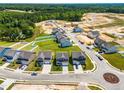 Aerial view of a new development showing several modern homes, landscaping, and community layout at 8869 Tartan Clan Dr, Willow Springs, NC 27592