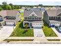 Aerial shot of a newly constructed two-story home with a manicured lawn and two-car garage at 8869 Tartan Clan Dr, Willow Springs, NC 27592