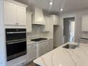 Modern kitchen with stainless steel appliances, white cabinets and granite countertops at 135 Ironwood Blvd # 49, Youngsville, NC 27596