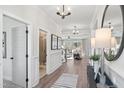 Inviting foyer with hardwood floors, chandelier, and views into the living spaces at 367 W Amber Oak Dr # 53, Selma, NC 27576
