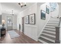 Welcoming foyer featuring hardwood floors, and staircase at 367 W Amber Oak Dr # 53, Selma, NC 27576