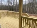 Spacious wooden deck with railing, perfect for enjoying the outdoor space and natural surroundings at 399 W Amber Oak Dr # 52, Selma, NC 27576