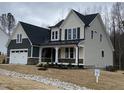 Charming two-story home showcasing a covered front porch, an attached two-car garage, and well-maintained landscaping at 399 W Amber Oak Dr # 52, Selma, NC 27576
