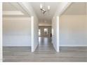 Bright hallway featuring hardwood floors, white trim and an open concept design at 135 Newport Lndg, Garner, NC 27529